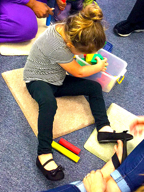 A child playing with tactile shapes.